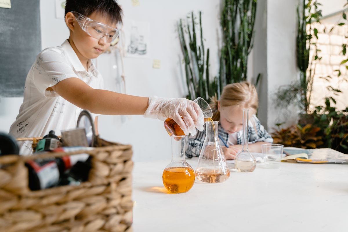 Students conducting an experiment with laboratory glassware in a science lab